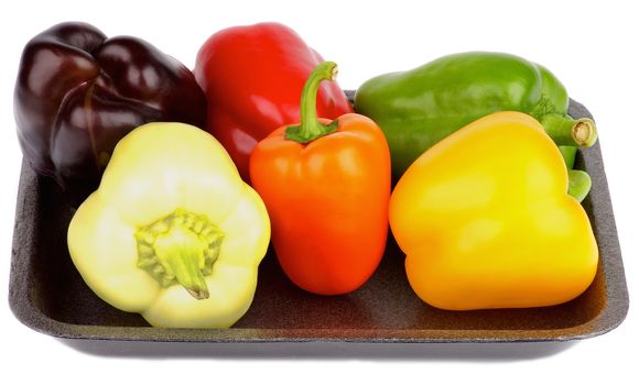 Various Fresh Colorful Bell Peppers on Black Plate isolated on white background