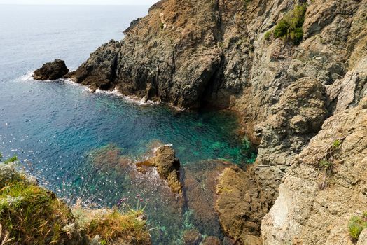 Small bay of the sea with high cliffs at Bonassola, ancient village in Ligurian coast in the east, La Spezia, Italy