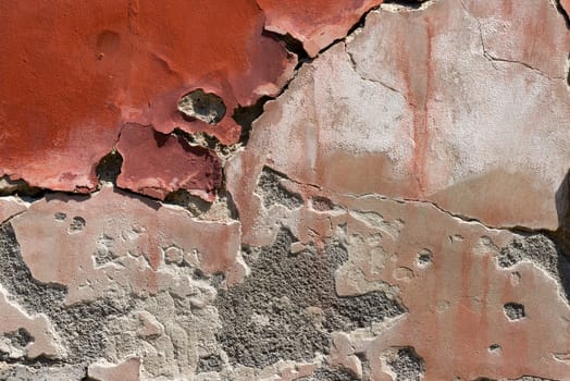 Old red, brown and white wall with cracked paint - vintage dirty wall
