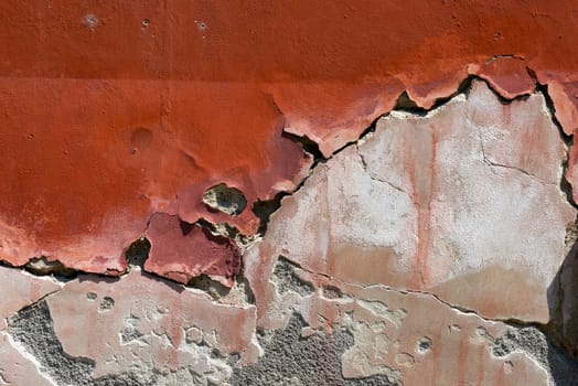 Old red, brown and white wall with cracked paint - vintage dirty wall
