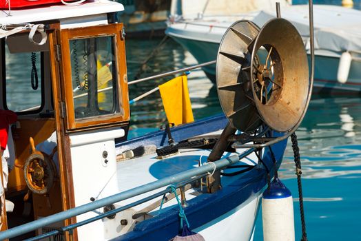Blue and white small fishing boat with fishing equipment docked in port - Lerici, La Spezia, Liguria, Italy