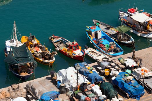 Many small fishing boats, red, yellow, blue and white with fishing equipment docked in port - Lerici, La Spezia, Liguria, Italy