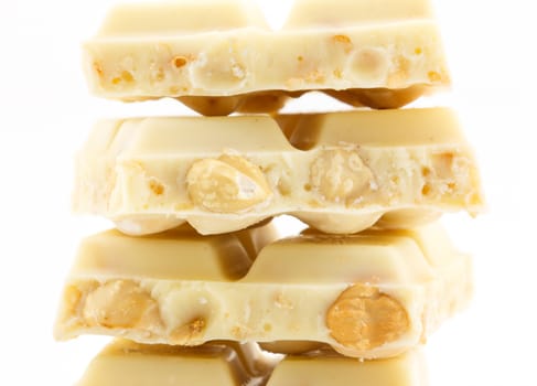 close up of white chocolate with nut on white background
