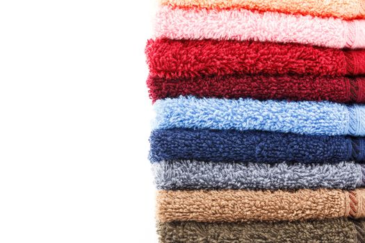 Stack of colorful towels isolated on white background