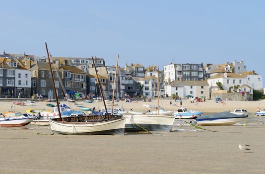 St Ives in Cornwall has boats on the beach on a sunny day in the summer
