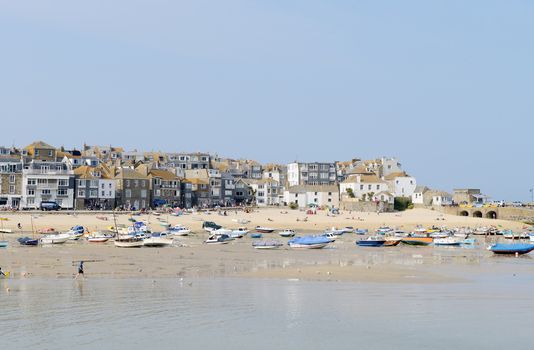 St Ives in Cornwall on s sunny summers day showing the beach with fishing boats