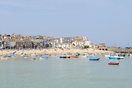 Fishing boats moored in harbour. St Ives, Cornwall, England. On a sunny day in the summer time.