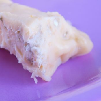 Gorgonzola cheese in close up over a purple plate