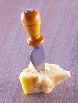 Parmigiano cheese with a small blade inserted