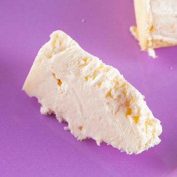 Ricotta cheese in close up over a purple plate