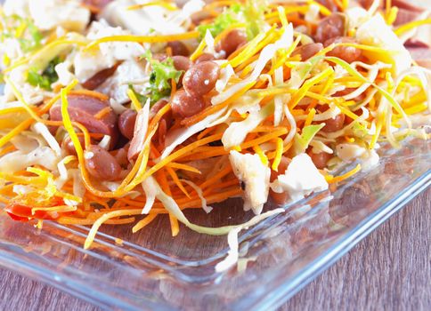 Rich salad with carrots, sausage, cheese and vegetables