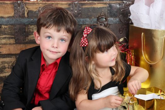 Brother and sister against a wooden background on christmas day