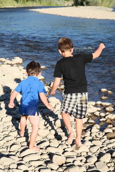 Two friends playing outside on pebble beach