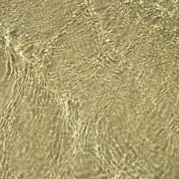 Clear ocean water on gold sand