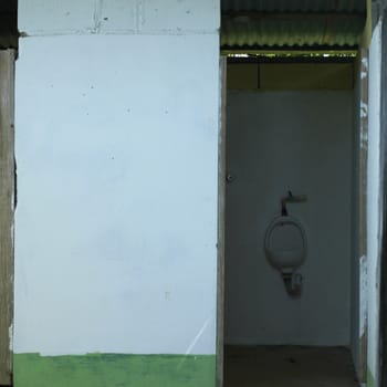 Urinal in a neglected washroom