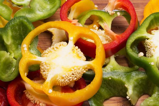 colorful pieces of pepper on plank