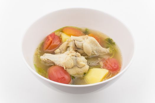 chicken soup with vegetables isolated on white background