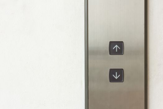 elevator black button up and down direction on wall