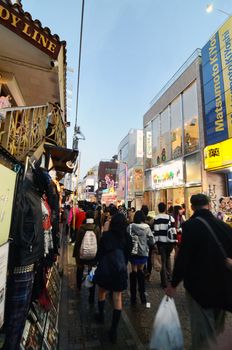 TOKYO, JAPAN - NOVEMBER 24, 2013 : Crowd at Takeshita street Harajuku on November 24, 2013 in Tokyo, Japan. Takeshita street is a street lined with fashion, cafes and restaurants in Harajuku. 