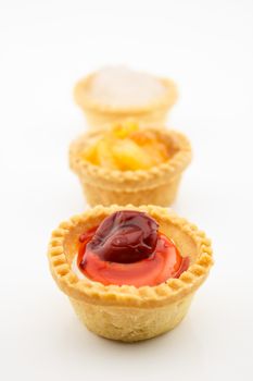 mini tart with red cherry jam isolated on white background
