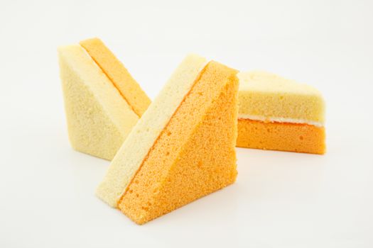 vanilla and orange chiffon cake Three pieces isolated on white background