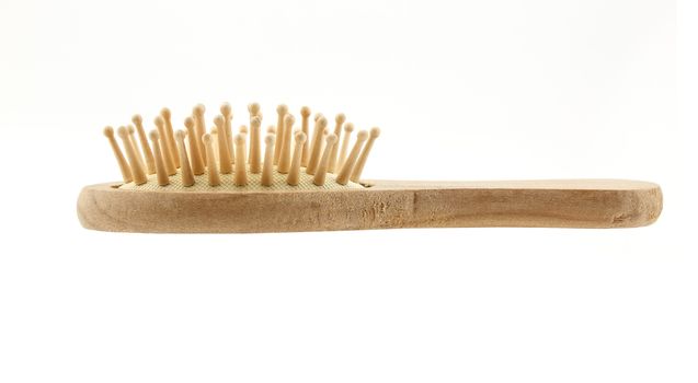 Wooden cushion hair brush isolated on white background