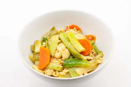 Fried stir cucumber with egg and vegetable for vegetarian on white background