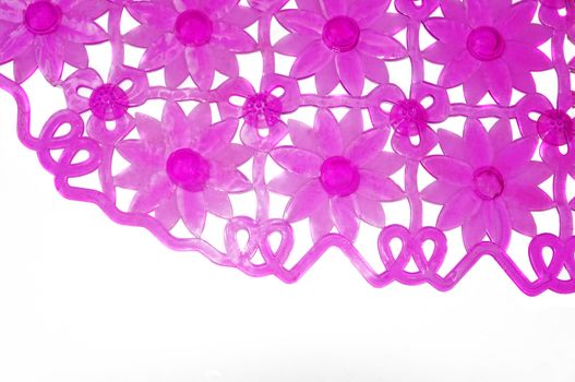 Purple rubber mat for bath with flower pattern as background                               