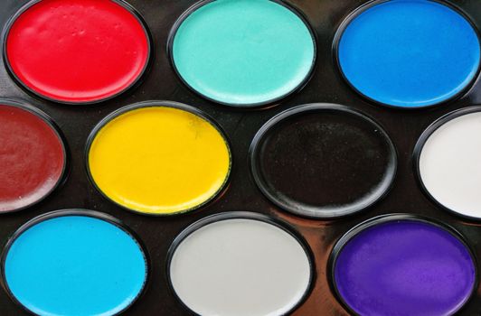 Watercolor paints in a box close up as background