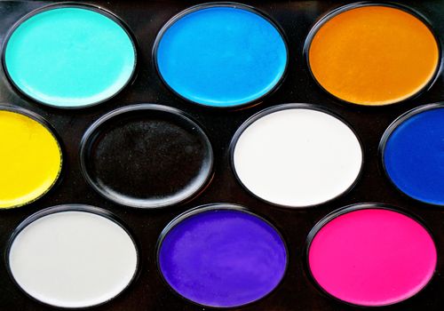 Watercolor paints in a box close up as background                               