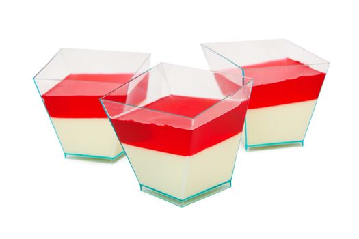 Dessert with cream and red jelly. Isolated on a white