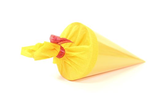 yellow school cone with red ribbon on a light background