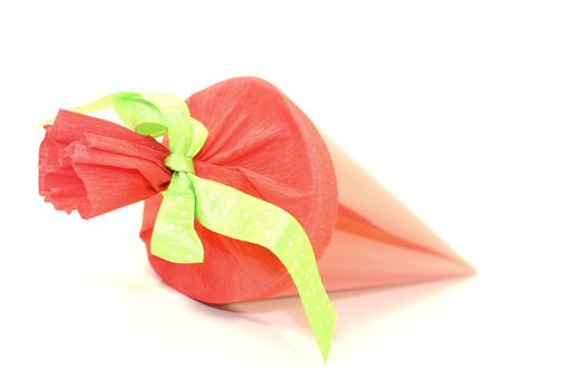 red school cone with green ribbon on a light background