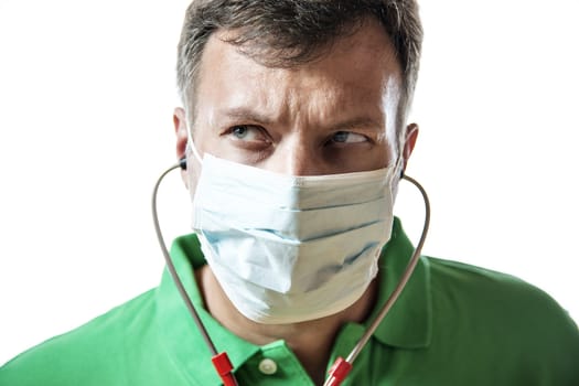 Desperate doctor in green shirt with surgical mask