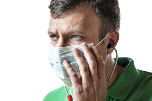 Desperate doctor in green shirt with surgical mask