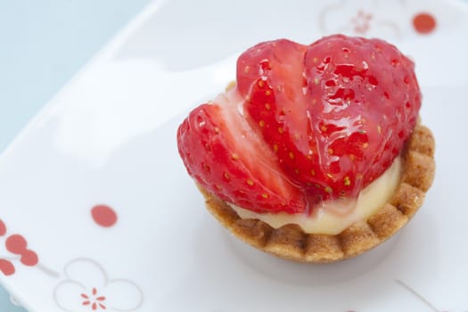Close-up picture of a strawberry dessert with background