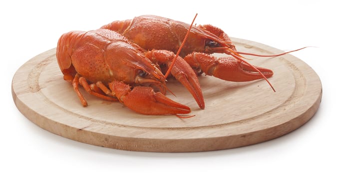 Isolated red boiled crawfishes on the wooden board