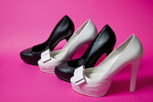 Leather woman shoes isolated on pink background