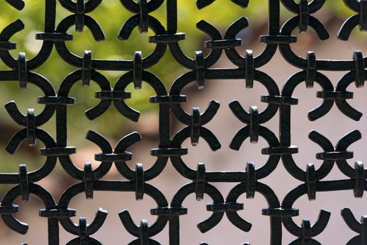 Silhouette of an old wrought iron fence painted with black color