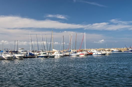 Sailboat and yacht anchored in a harbor.