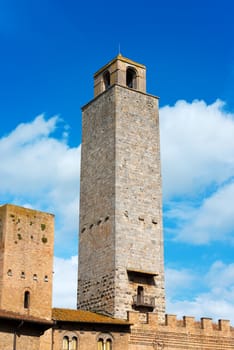Two towers and buildings in Piazza del Duomo, San Gimignano medieval town (UNESCO heritage), Siena, Tuscany, Italy