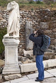 Tourist with a photo camera in Ephesus, Turkey