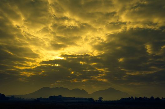 The Sun try to rise with Cloud in Country Field.