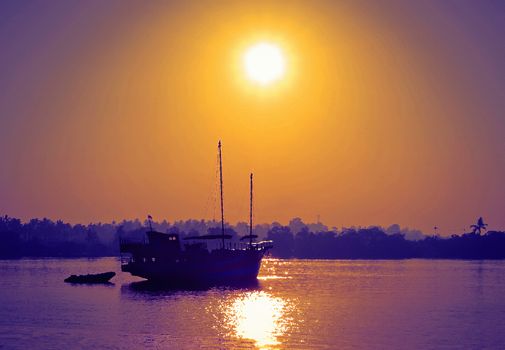 The wooden boat on river in the Sunrise