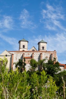 The Benedictine Abbey in Tyniec with wisla river on blue sky background