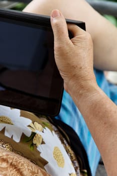 Senior woman using tablet at home