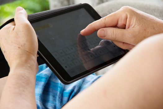Senior woman using tablet at home