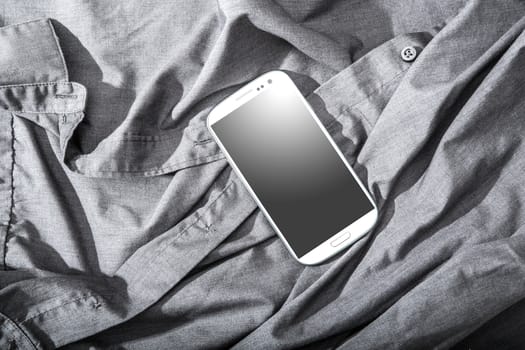A Smartphone on some dark cloth.