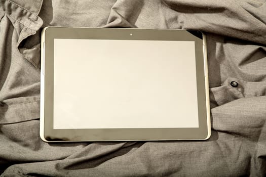 A Tablet PC on some dark cloth.