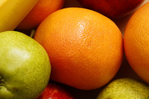 A background of Fruits - Oranges, Bananas, Apples and Pears.